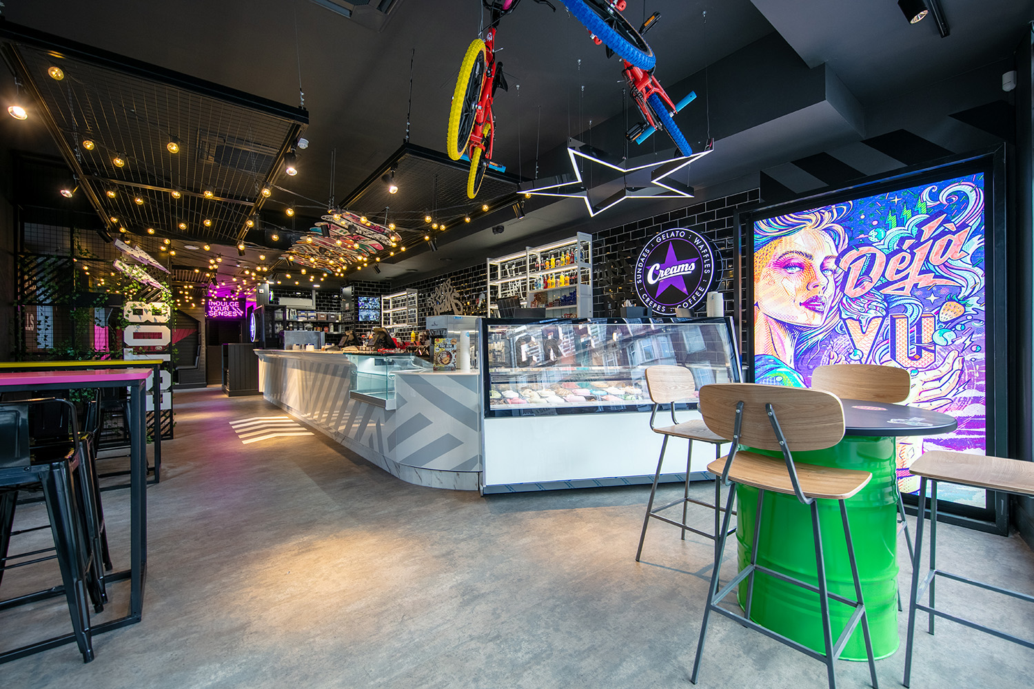 Dessert display counter and seating in a colourful dessert cafe