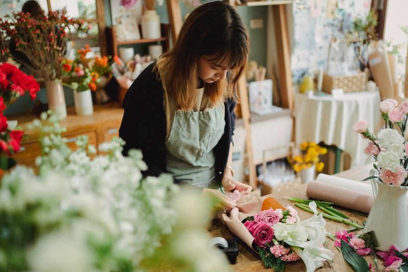 Florist arranging a bouquet in a flower shop