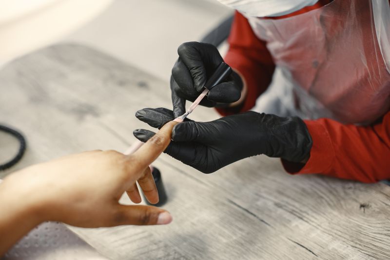 Nail technician giving a client a manicure